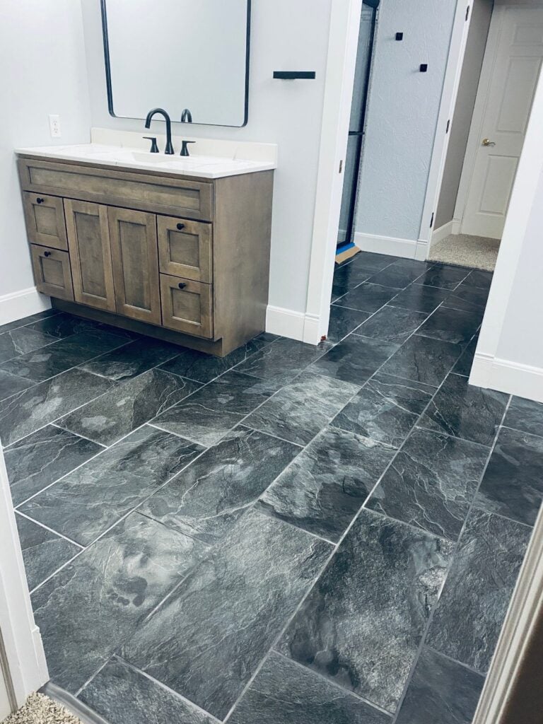 Large format slate look tile floor in a remodeled bathroom in Amherst, WI