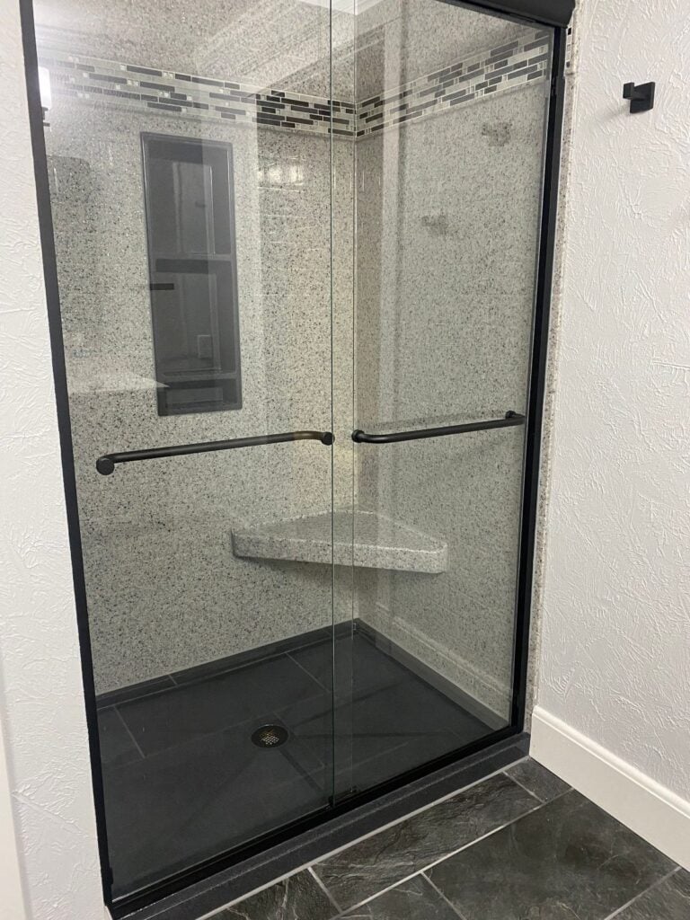 Onyx shower with glass door and grout free wall panels in Amherst, WI